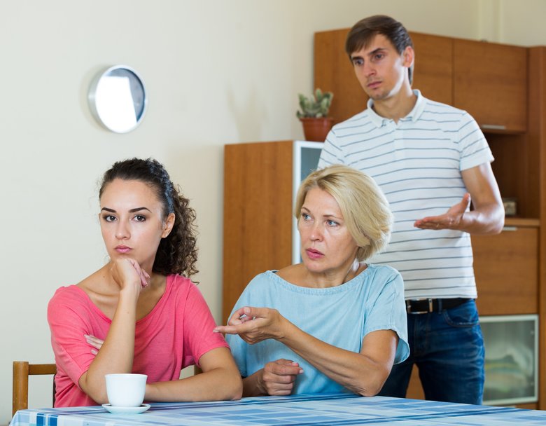 Elderly mother and young man blaming girl in something