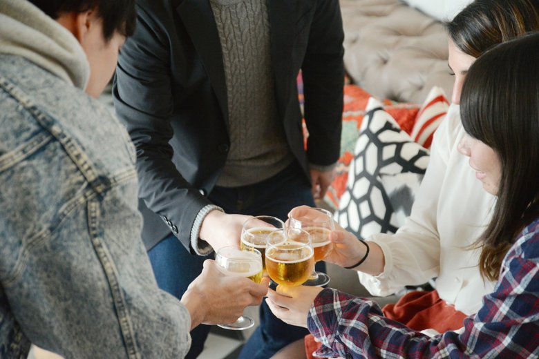 Various ethnic young people enjoying drinking together