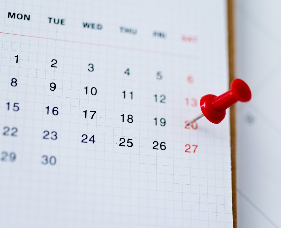 Red push pin in calendar