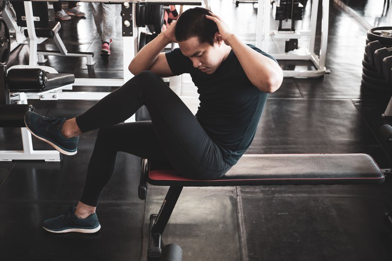 Attractive young man working out at the gym.