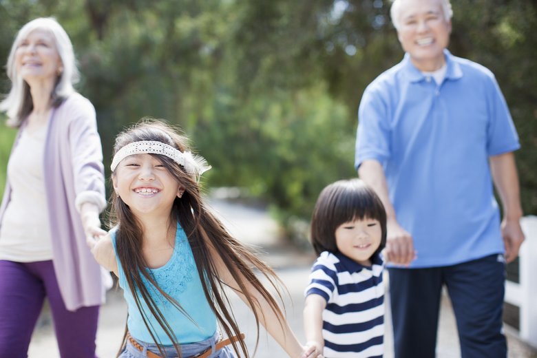 Older couple and grandchildren walking outdoors