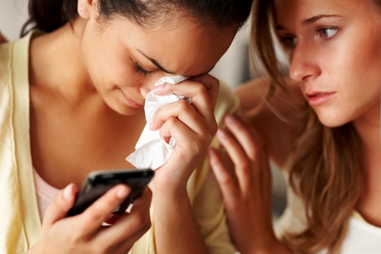 Young girl in sorrow with a friend consoling her