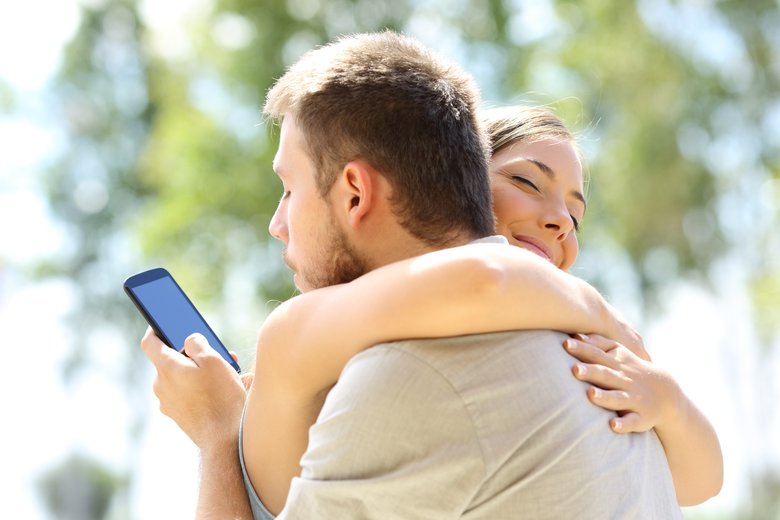 Cheater hugging his innocent girlfriend