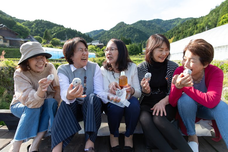 Group of senior Japanese female eating sweets