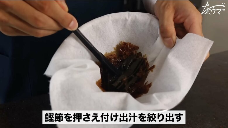 【作り方4】ザルを持ち上げてしっかりと鰹節を押さえて出汁を出す