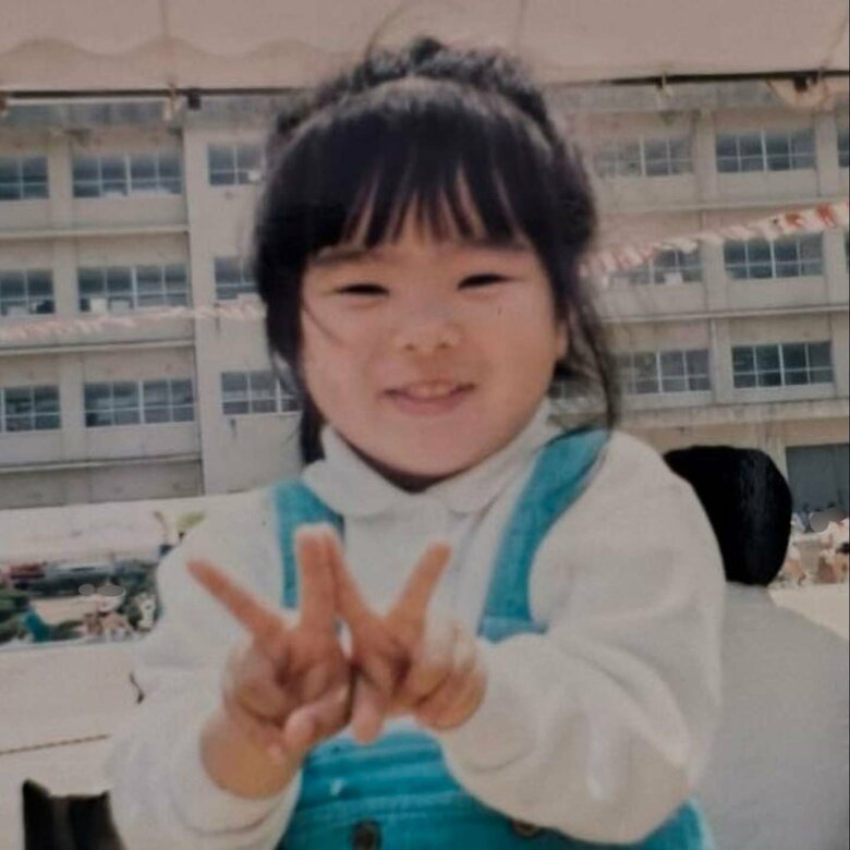 5歳のころ、兄の小学校の運動会の応援に来て決めポーズをしている徳丸さん