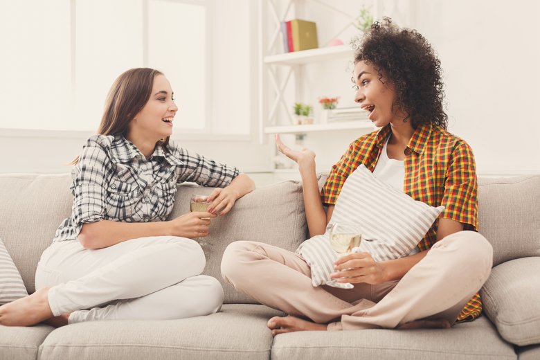 Friends chatting with wineglasses at home