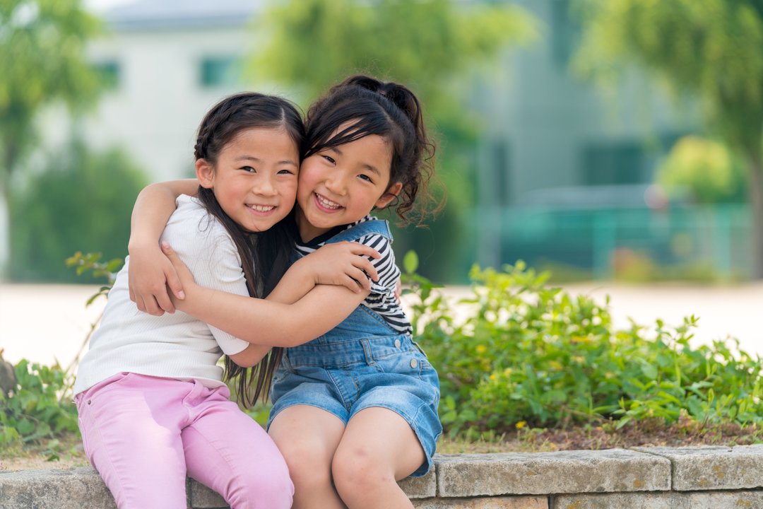 Portrait of two sisters hugging
