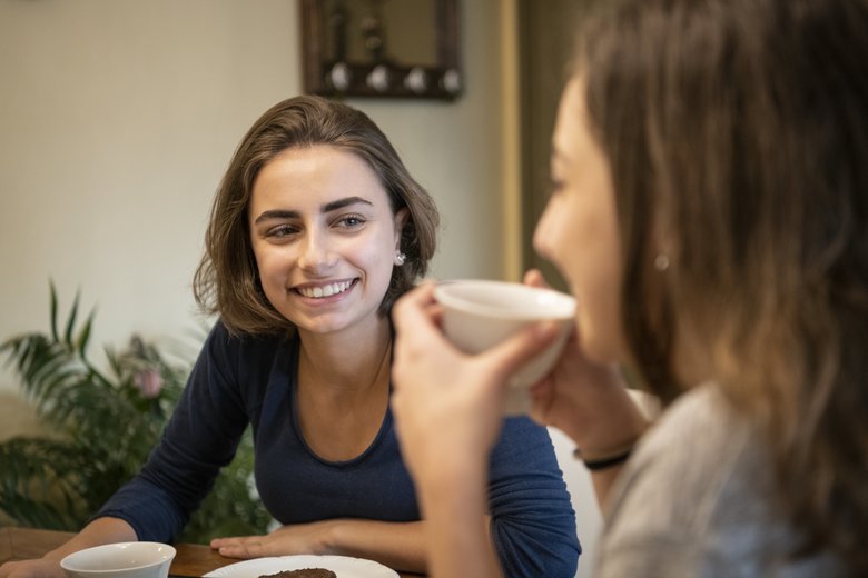 Attractive young woman smiling at friend