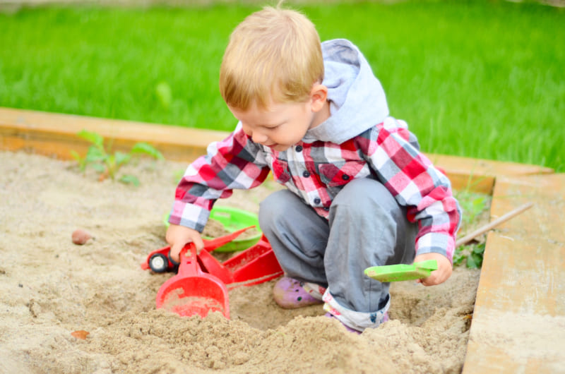 Young boy playing in the sandbox