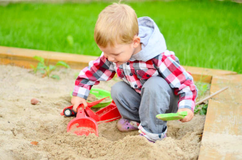 Young boy playing in the sandbox