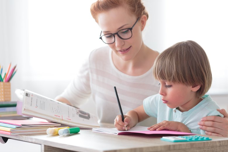 Mother helping son with homework