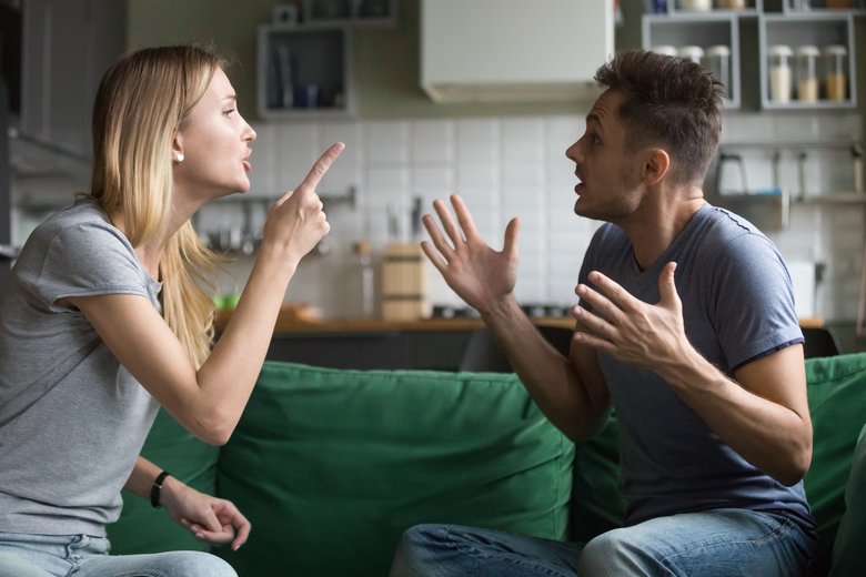 Angry millennial couple arguing shouting blaming each other of problems