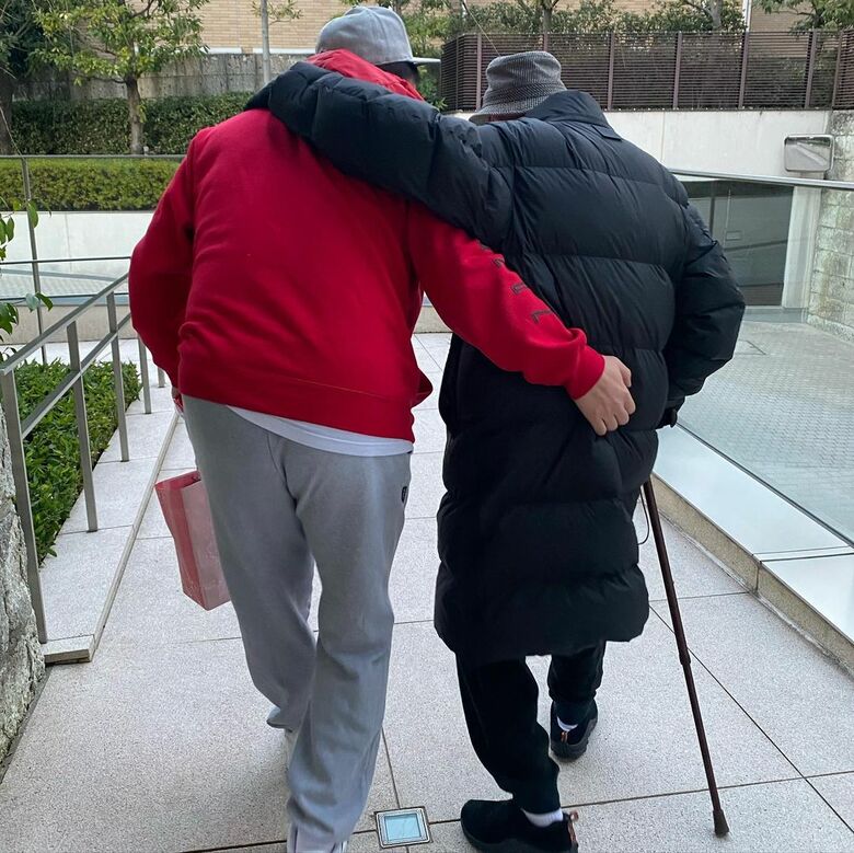 石井さんが木佐さんのお父様を支えて歩く後ろ姿