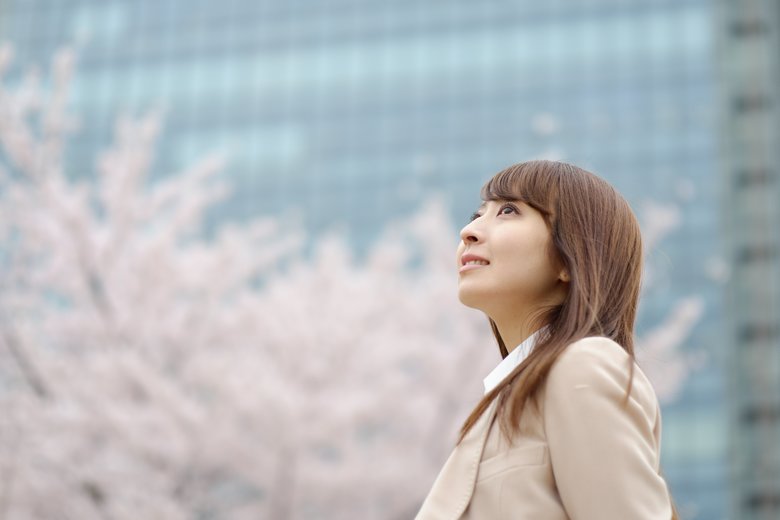 businesswoman who is relaxed in front of a cherry tree