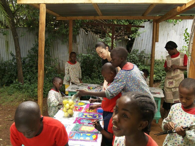 スラムの子どもたちが通う学校のアートクラスを担当する伊藤さん（写真中央・奥）