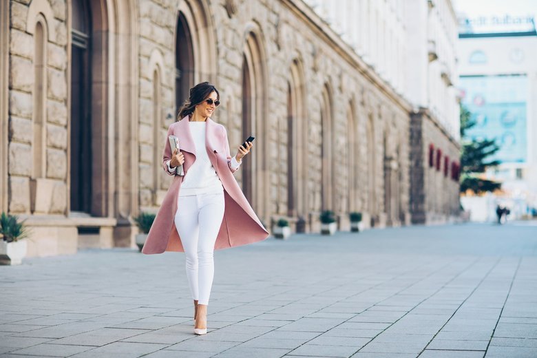 Fashionable woman texting outdoors