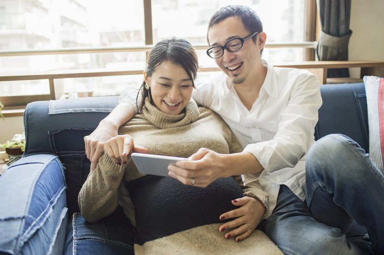 Pregnant woman with her husband in room