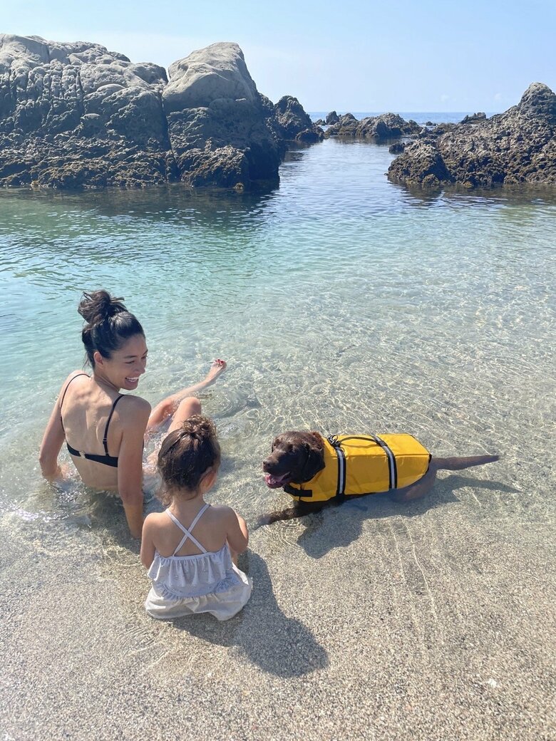 ビーチで家族時間を楽しむ森さんとお子さん。ワンちゃんもライフジャケットを着て泳ぎます！