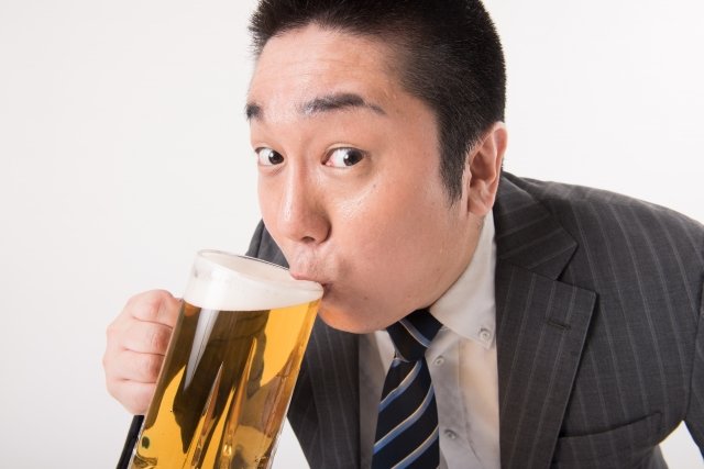ビールを飲む太った旦那さんの画像
