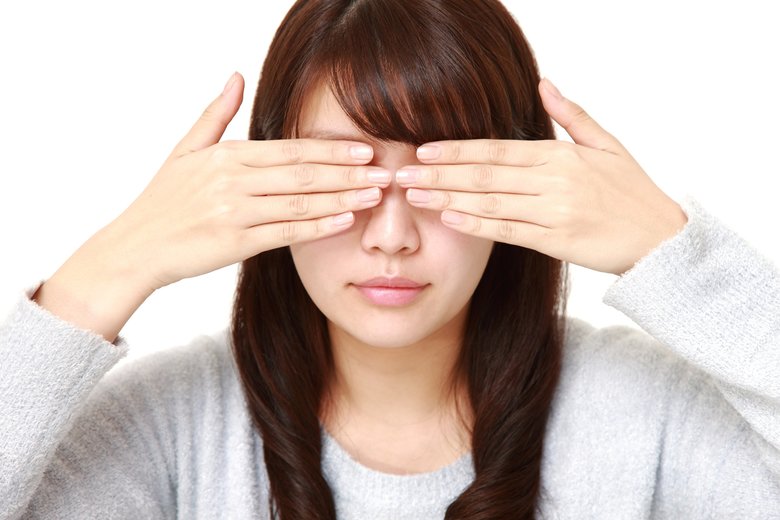 woman covering her face