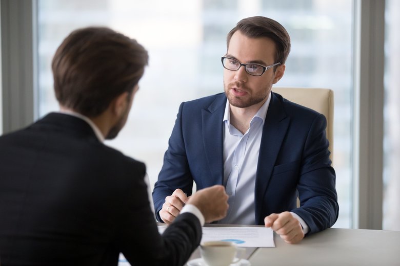 Focused businessmen negotiation on company strategies in office