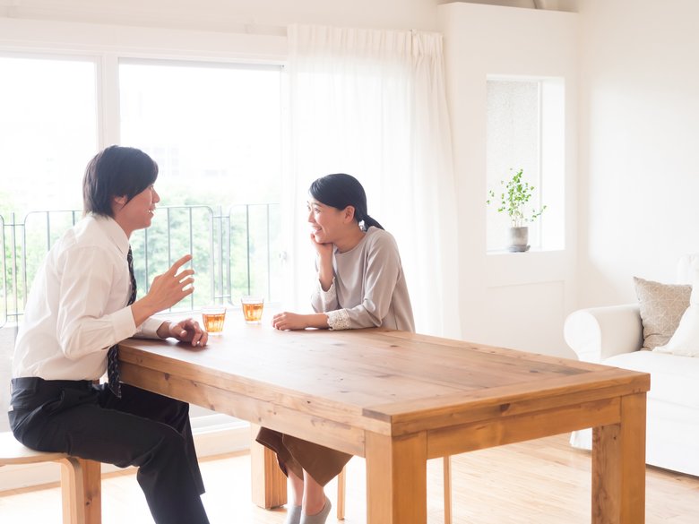 young asian family talking in living room