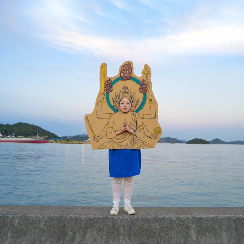 「大威徳明王」に扮し、海をバックに撮影するニシユキさん