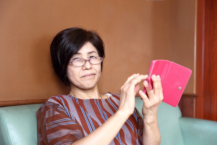 Senior woman eating sweets indoors