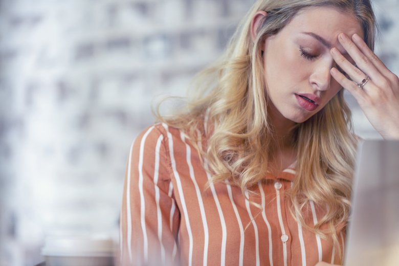 Woman stressed or worried with a headache.