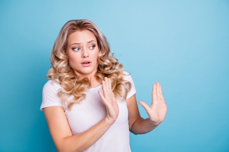 Close up photo oh no her she lady awful awkward situation look side empty space ugh facial expression hands arms up air wear casual white t-shirt jeans denim clothes outfit isolated blue background