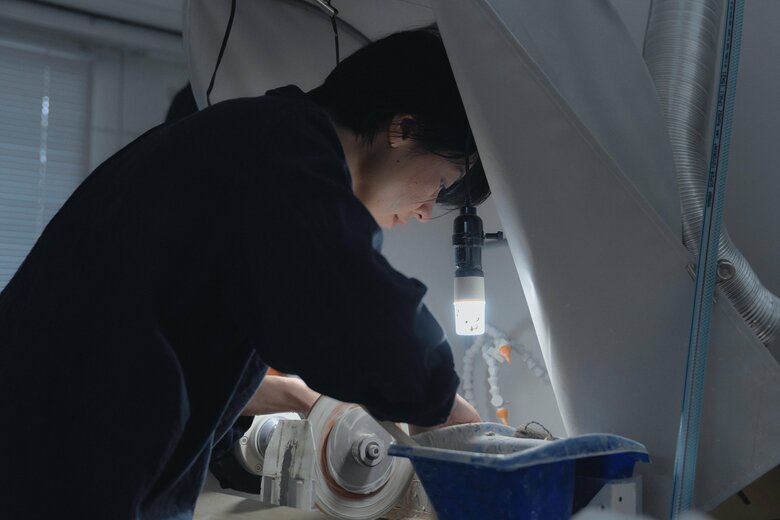 高速回転する円盤でガラスに彫り模様をつけていく切子作家の三澤世奈さん（写真／安宅美咲）