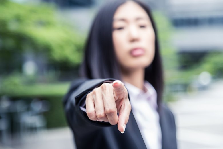 Female Corporate Executive pointing towards the camera
