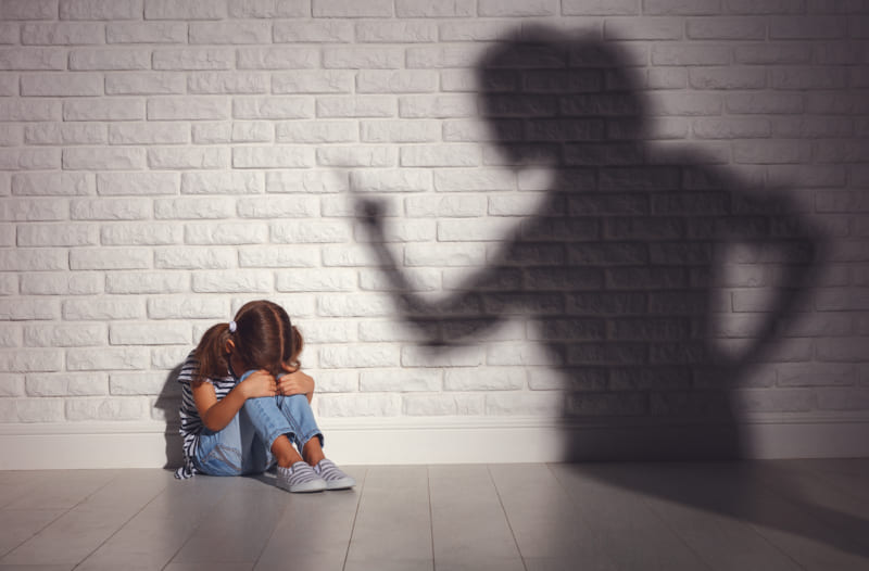 domestic violence. angry mother scolds frightened daughter