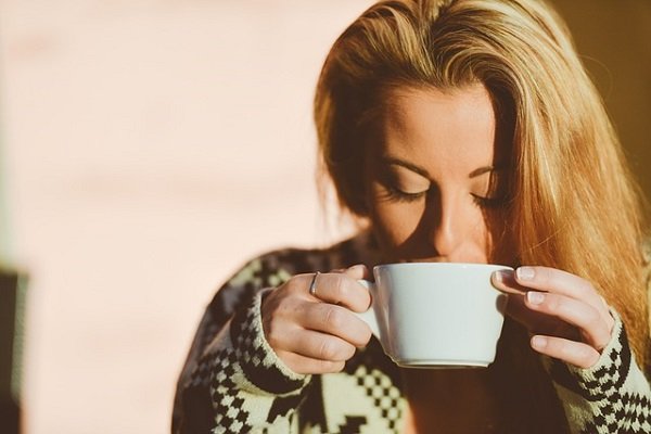 疲れてホットミルクを飲む女性の画像