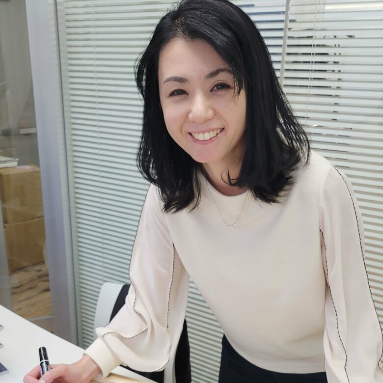 2025年11月の写真展でファンにサインする小島さん
