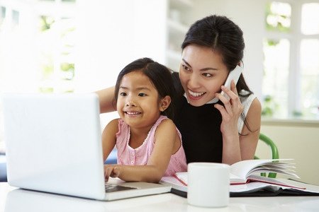 31046450 - busy mother working from home with daughter