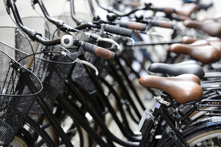 row of bicycles on the street in rainy weather